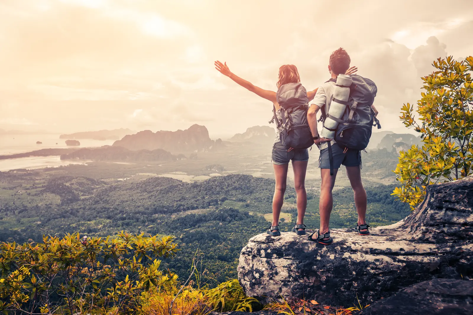 Two travellers looking out over a valley